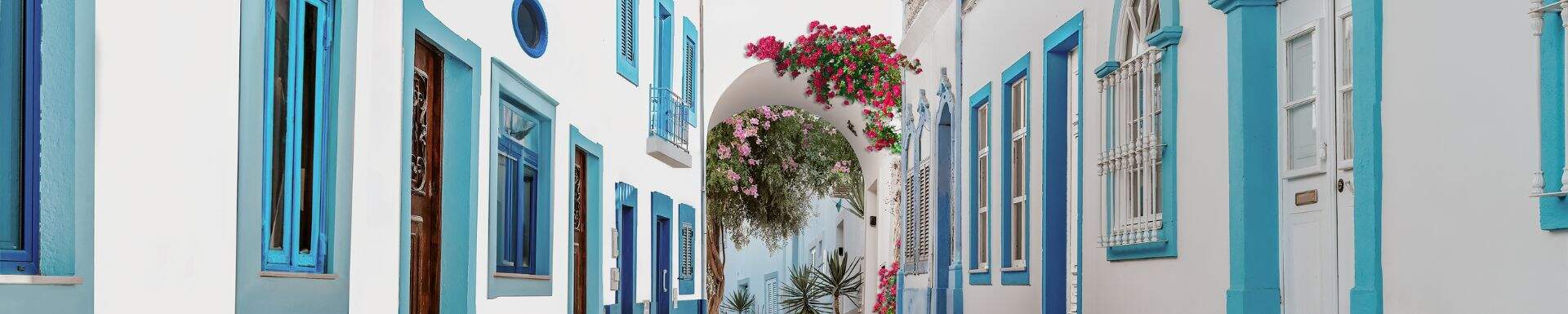 Witte huisjes met blauwe accenten in een straatje in de Algarve